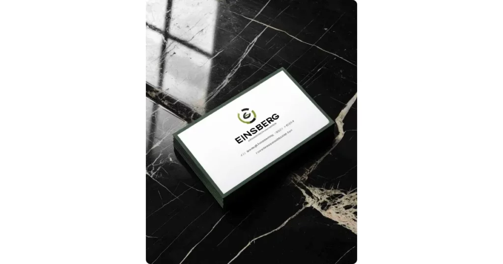 a business card on a dark marble