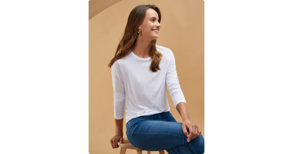 a female model sitting on a stool