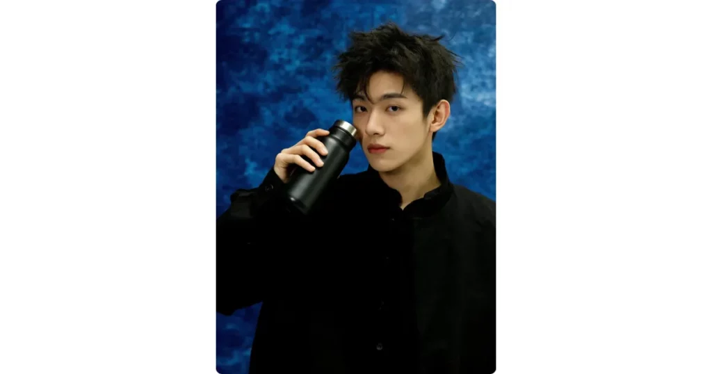 a black bottle held by a model